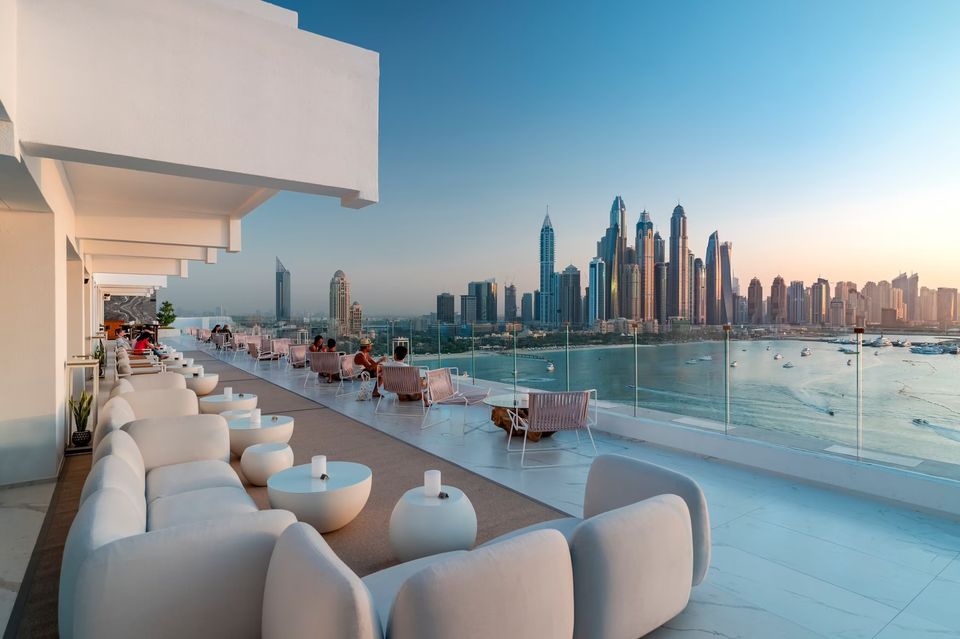 People relaxing on a beautiful beach at a Dubai beach club in 2024, enjoying the sun and luxury